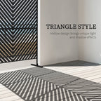 Black metal privacy screen with triangle cutout pattern and freestanding legs