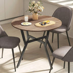 Round brown dining table with black metal legs and smooth wood tabletop