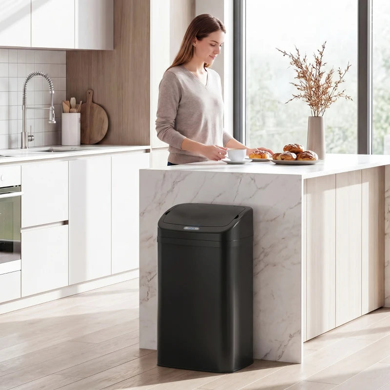 Black 48 L sensor trash bin placed under kitchen counter, lid closed and ready.