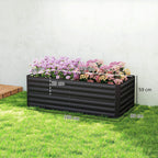 Black raised garden bed planter on grass, filled with flowering plants