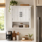 White wall cabinet open, two interior shelves with jars, bottles, and folded towels