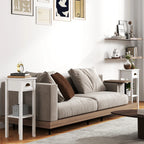 White bedside table set with drawers and open shelves next to sofa