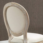 Cream upholstered oval back dining chair with distressed wooden frame
