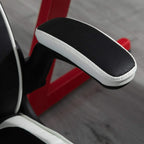 Black padded flip-up armrest with white trim on black and white ergonomic gaming chair