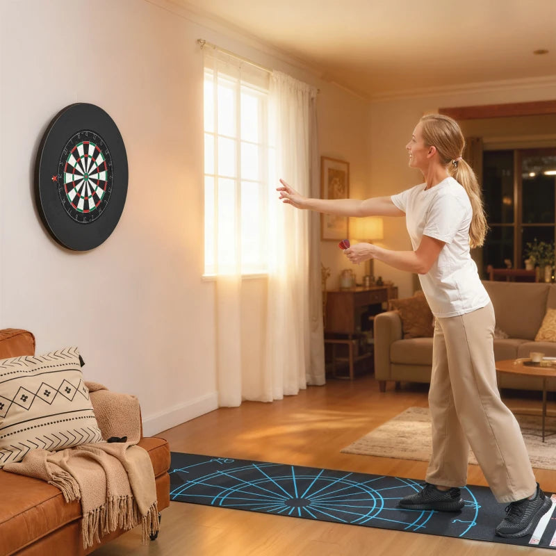Wall-mounted black bristle dartboard with a blue floor target mat
