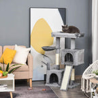 Grey cat tree with stacked condos and hammock perch; cat resting on top pad