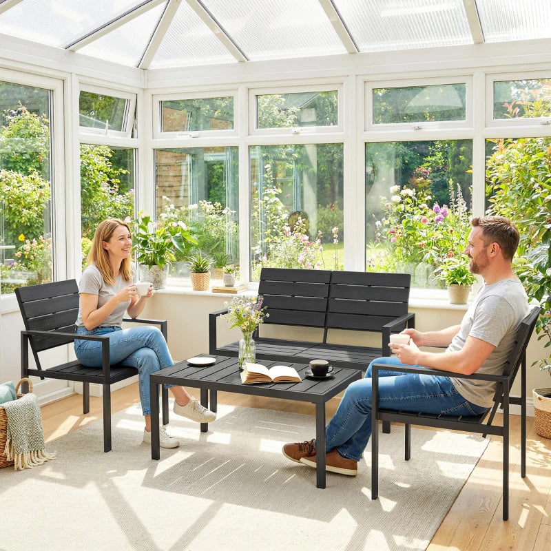Black outdoor loveseat and armchairs set with slatted seats and metal frames in sunroom.