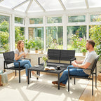 Black outdoor loveseat and armchairs set with slatted seats and metal frames in sunroom.