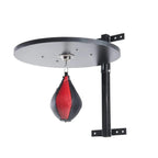 Wall-mounted swivel bracket with round platform and hanging red/black speed bag.