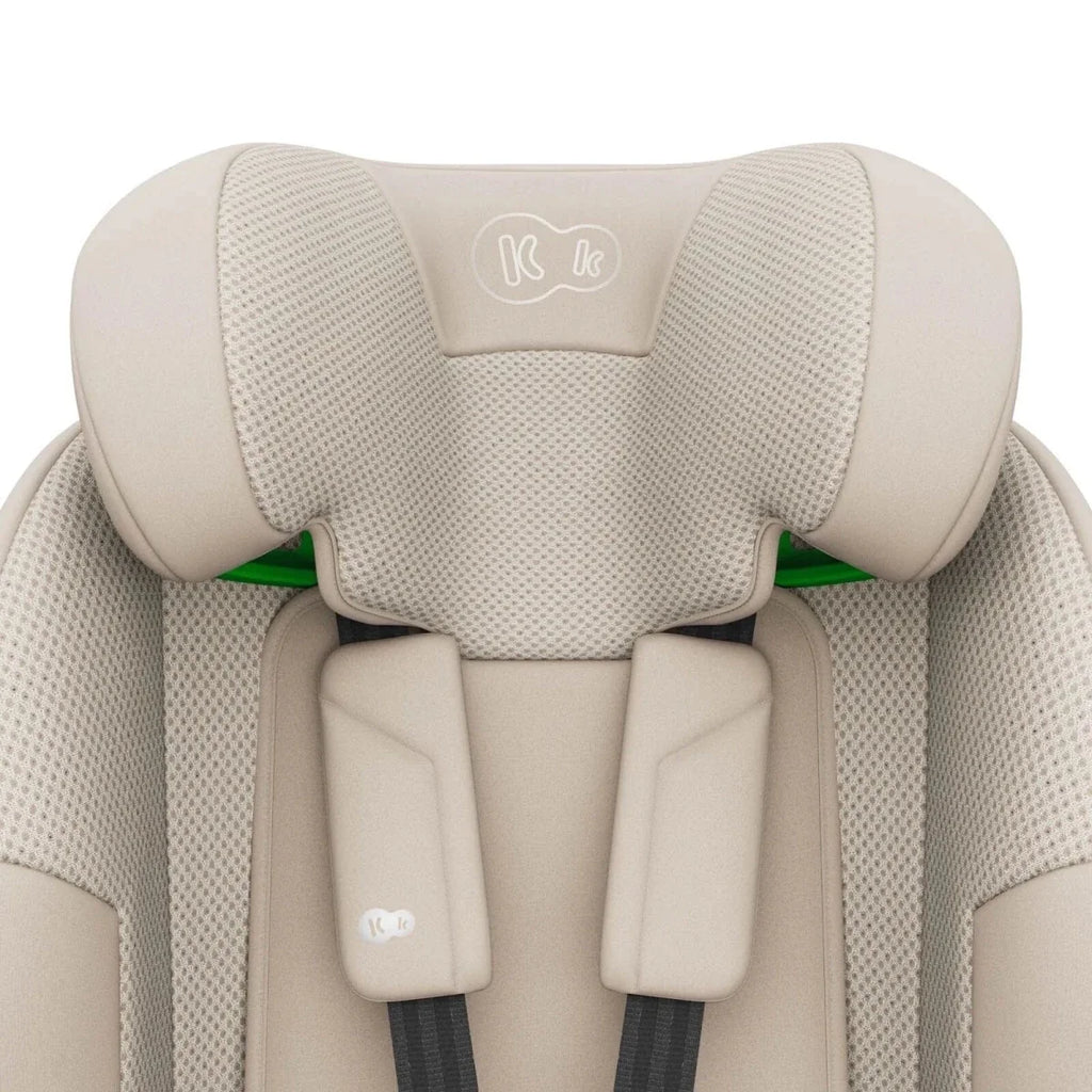 Beige child car seat headrest with K logo and padded side support wings