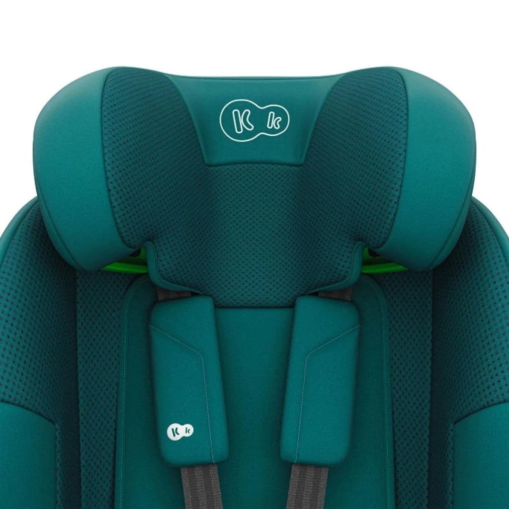 Green car seat close-up of backrest padding and headrest support wings.