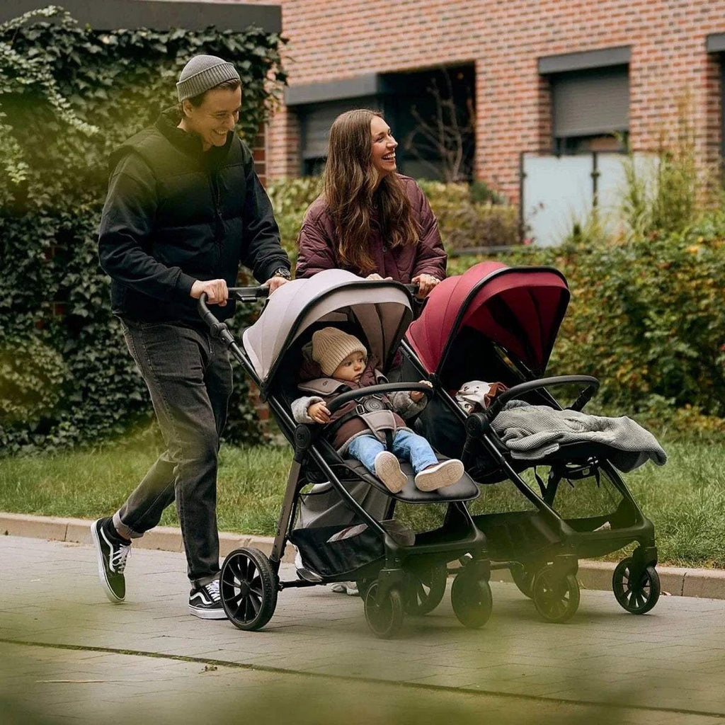 Stroller size and folded view diagram with black seat, canopy, and 4-wheel base