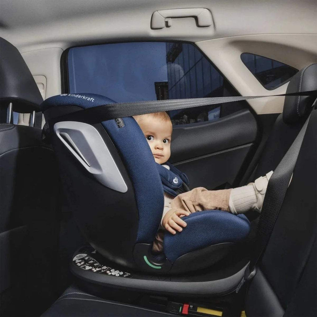 Blue and dark car seat with harness, rear seat close-up view