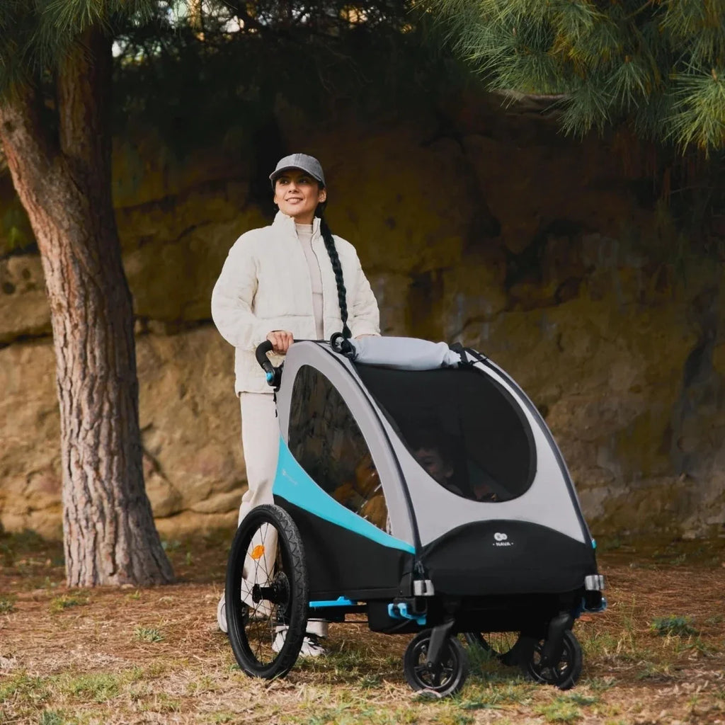 3-in-1 stroller front three-quarter view with dark canopy and turquoise details