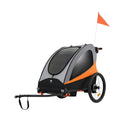 Orange and black stroller with canopy, handle bar, and large rear wheels