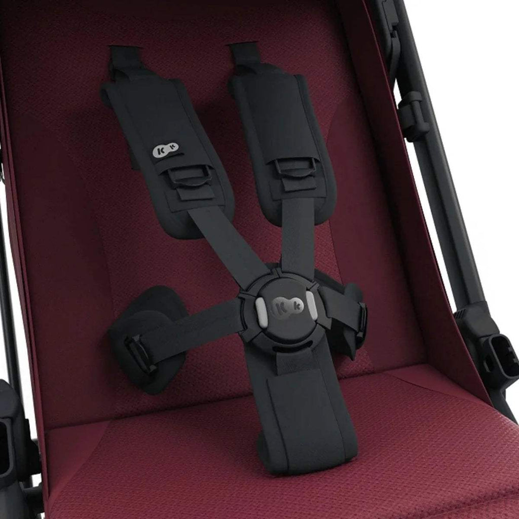 Dark ruby stroller seat with black five-point harness and shoulder straps