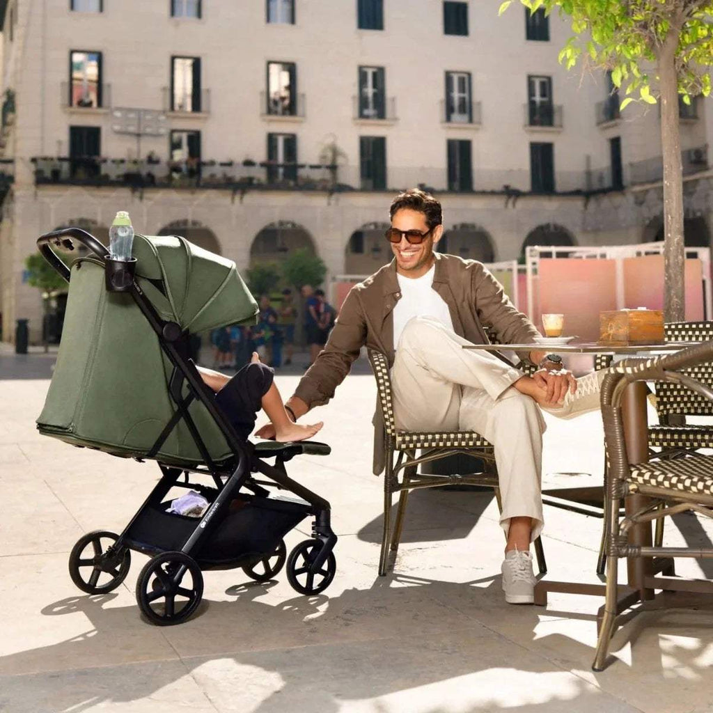 Compact baby stroller in dark green with canopy and all-terrain wheels