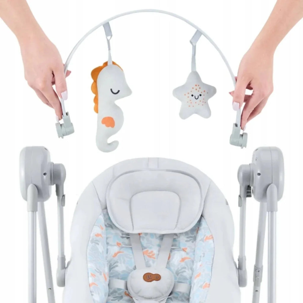 Grey electric baby rocker with overhead toy bar featuring star and seahorse plush pieces