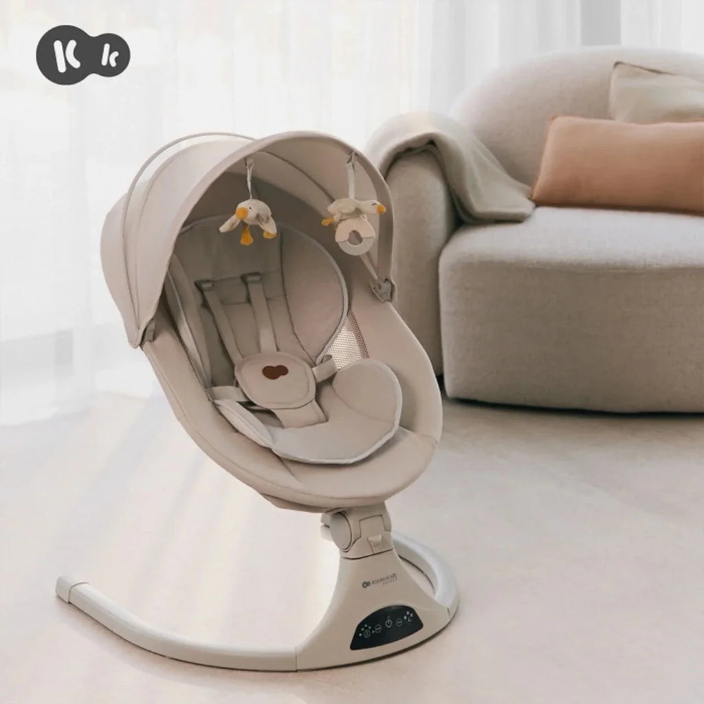 Grey baby swing seat with canopy and hanging toy arch over padded infant liner
