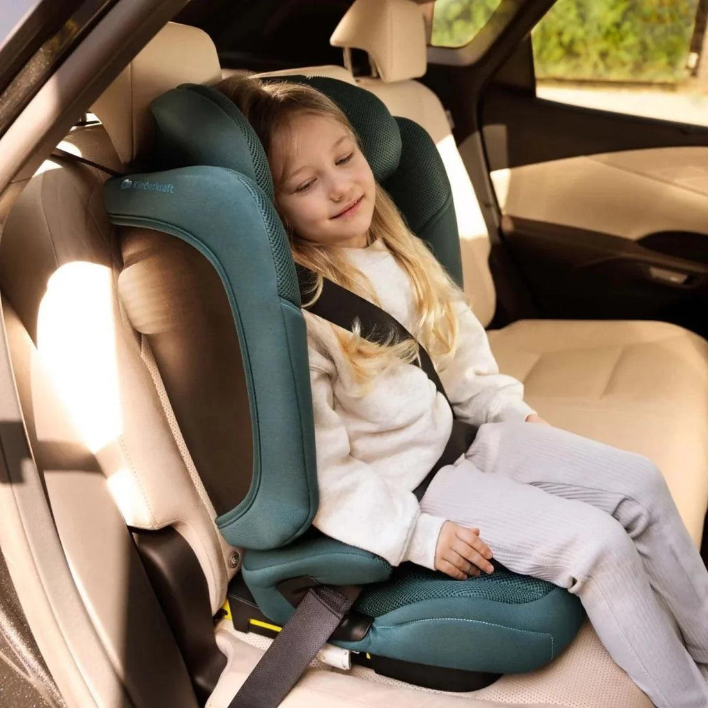 Child car seat with padded headrest and harness belt, shown in vehicle with child