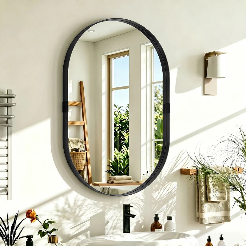 Black oval wall mirror mounted on wall with sleek rounded frame