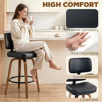 Black bar stool with padded curved back and thick seat cushion, light wood legs