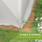White greenhouse base edge for anchoring, shown on soil with 50 cm marker