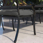 Charcoal gray seat cushion with ties, padded quilted square on outdoor chair
