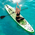 Green inflatable SUP board with non-slip deck, paddler holding paddle on open water