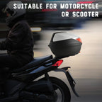 Black and white motorcycle top case mounted on scooter with helmet inside