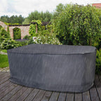 Grey waterproof outdoor table chair cover laid over furniture on a patio
