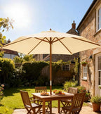 Cream-white patio market umbrella over outdoor dining table with wooden pole