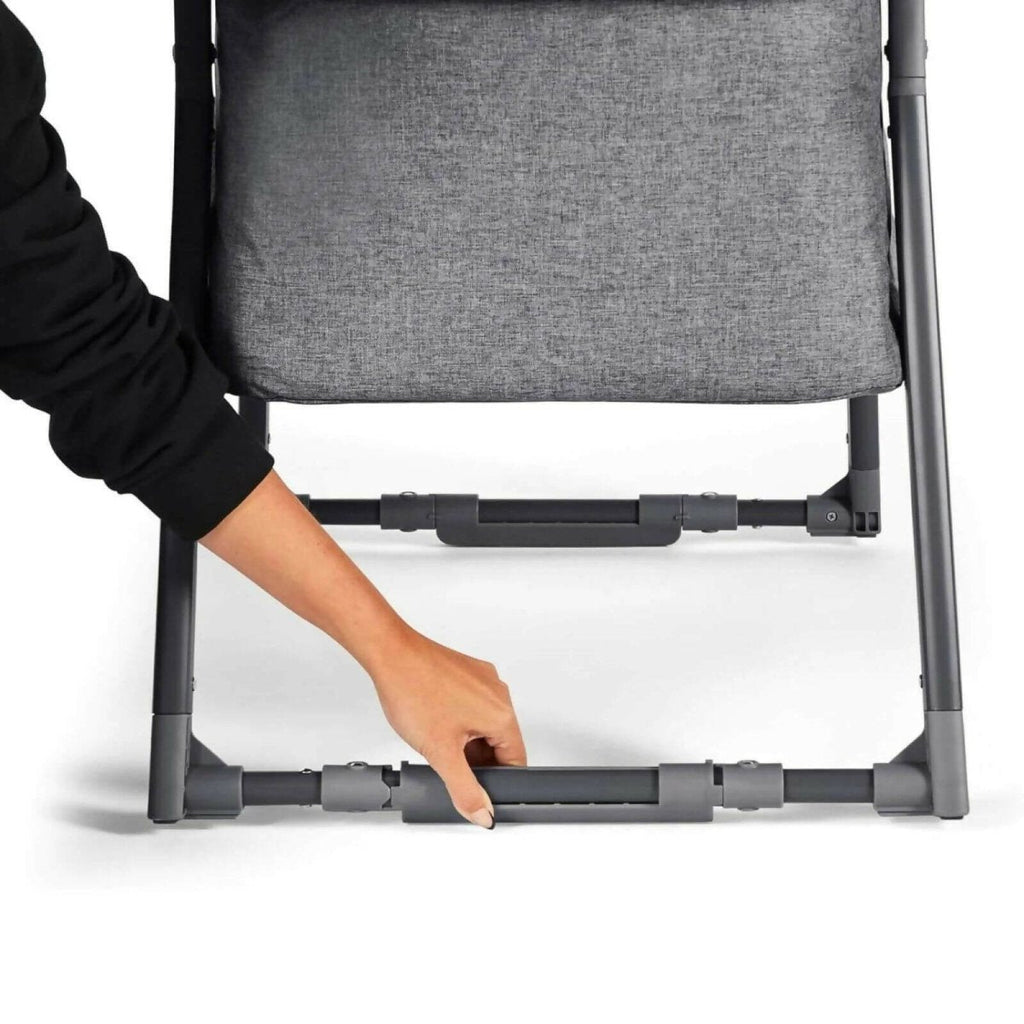 Space Grey mini crib showing adjustable lower side support bar and gray frame.