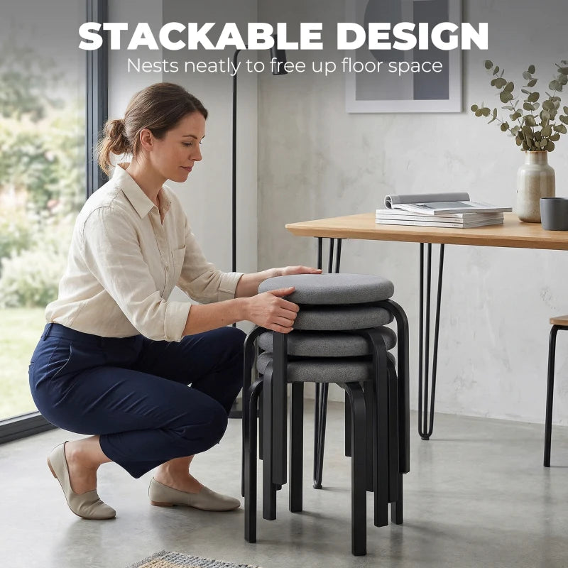 Set of 4 stackable dark grey round cushioned backless stools with black legs