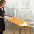 Natural wood extendable dining table showing folded extension panel mechanism