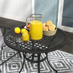 Black round aluminium patio table with slatted grid top and central parasol hole