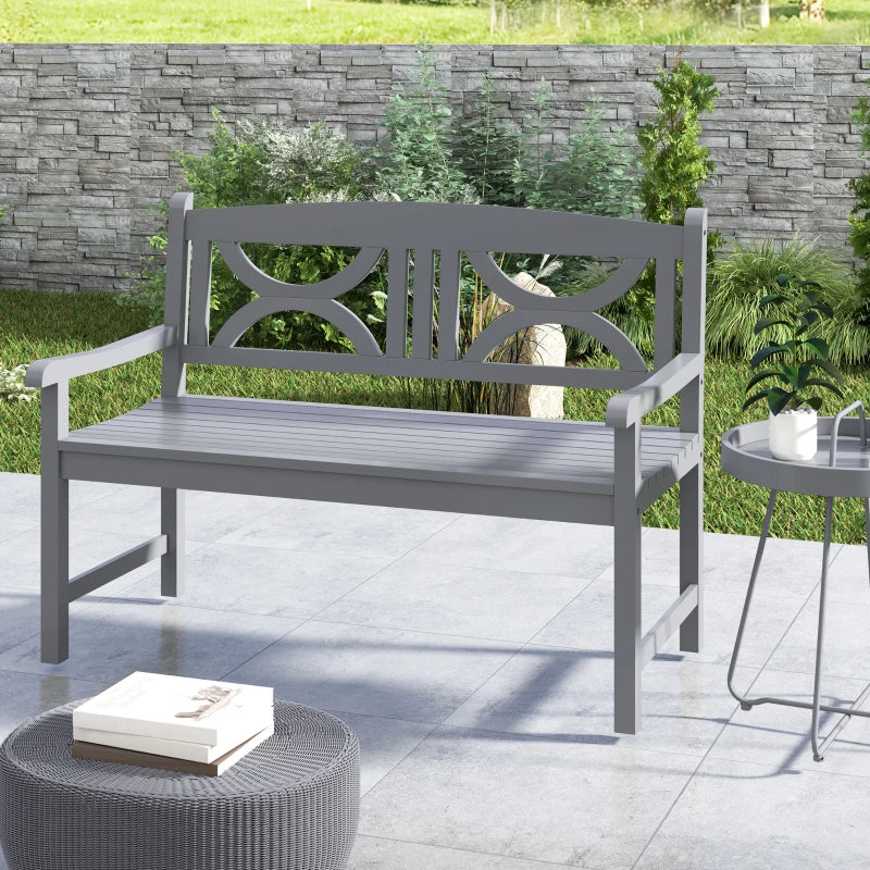 Grey outdoor bench with armrests and slatted seat, decorative cutout backrest