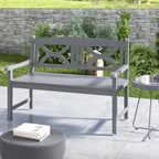 Grey outdoor bench with armrests and slatted seat, decorative cutout backrest