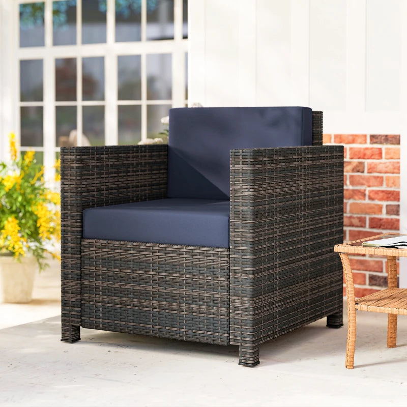 Rattan garden armchair with navy cushion, mixed brown woven sides and wide armrests.