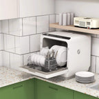 White countertop dishwasher with open door, loaded dish rack and utensil holder