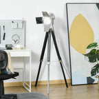Tripod floor lamp with adjustable spotlight head and black tripod legs