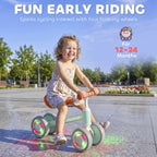 Orange-seat toddler balance bike with glowing LED wheels and green frame, adjustable seat
