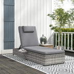Grey PE rattan sun lounger with cushion and small side tray on patio