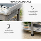Grey potting table with three metal hooks on side rail and slatted feet