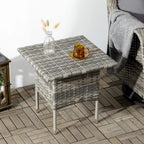 Grey woven side table with square top and cups on a patio