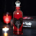 Decorative red glass bottle with clear globe stopper and heart "Love Potion" label