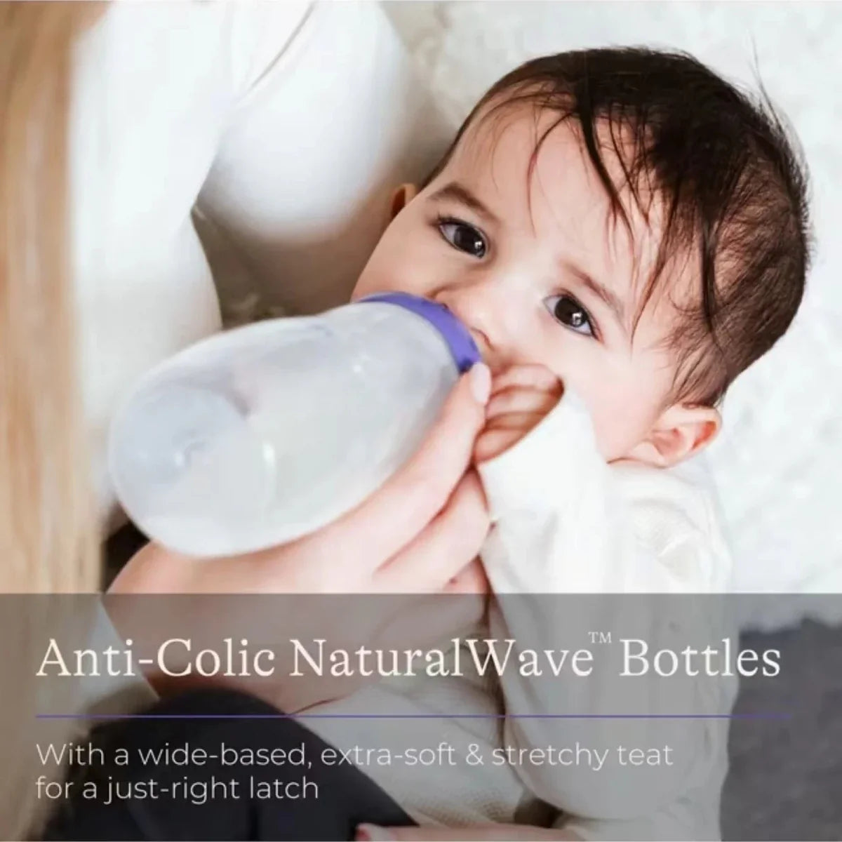 Feeding bottle with NaturalWave teat held by a baby during feeding