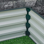 Green raised garden bed corner with slatted sidewalls and multiple attached support screws