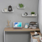 White floating wall shelves with curved profiles displaying decor, books, and a clock.