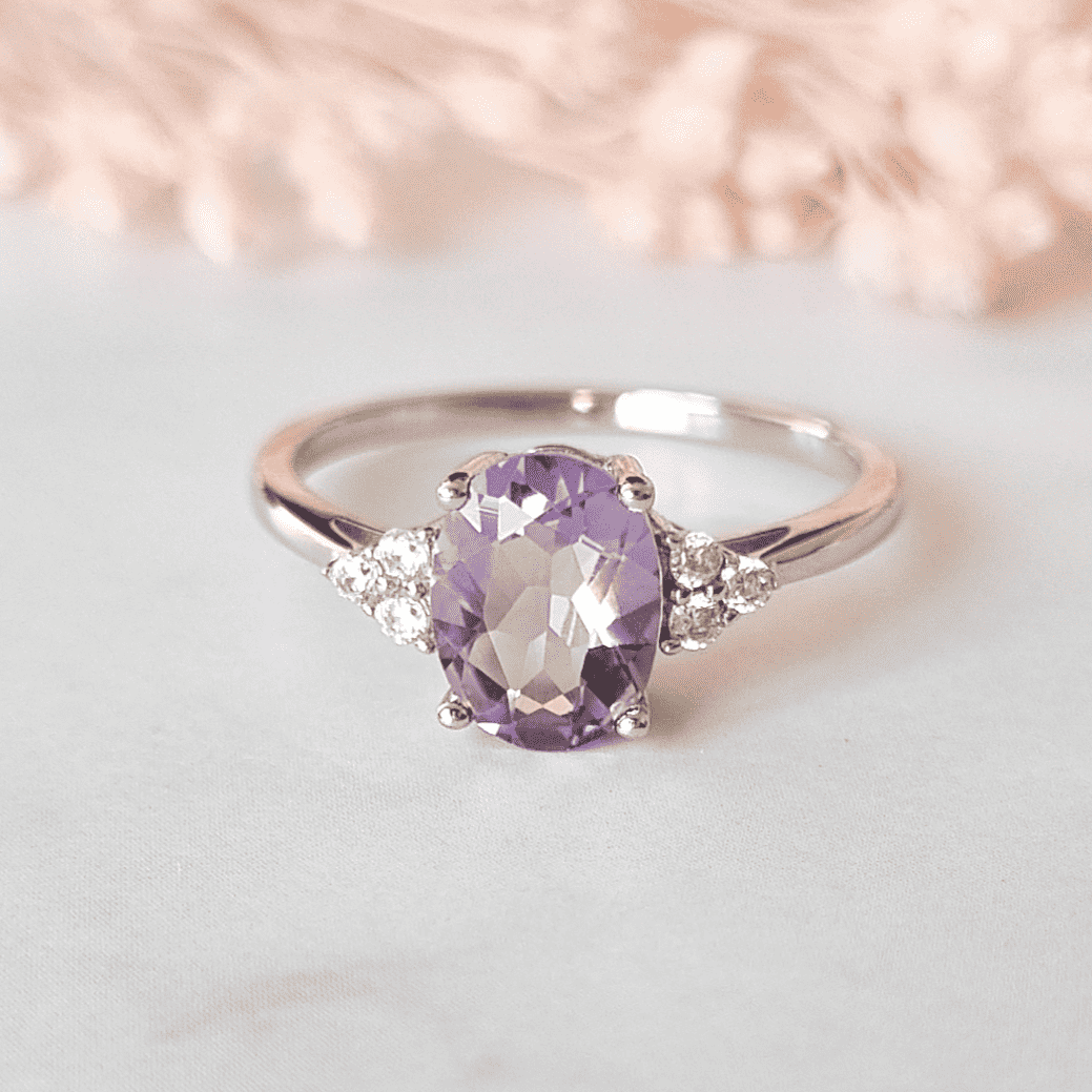 Oval lavender amethyst ring in sterling silver with small diamond clusters on band